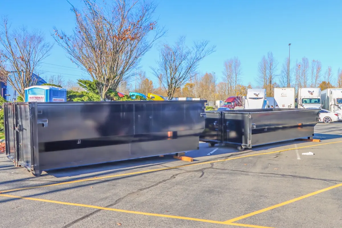 Professional dumpster rental service with roll-off container on residential driveway in Silverton